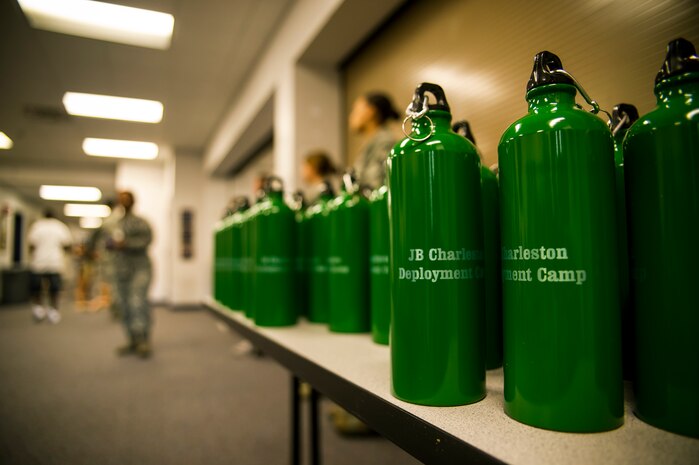 Canteens sit on a table to be distributed to participants of the Children's Deployment Camp, Aug. 14, 2012, at Joint Base Charleston - Air Base, S.C. The Children’s Deployment Camp, hosted by the Airman and Family Readiness Center, offered children, age five to 14 whose parents have recently returned from deployment, are currently deployed or are scheduled to deploy within the next six months, the opportunity to experience many of the same things their parents have to go through to prepare for a deployment. (U.S. Air Force photo by Airman 1st Class George Goslin)