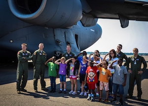 Joint Base Charleston – Weapons Station Youth Center children pose with loadmasters and pilots from the 15th and 16th Airlift Squadrons, 437th Airlift Wing, during the Children’s Deployment Camp, Aug. 14, at JB Charleston – Air Base, S.C. The camp included a tour of the C-17 Globemaster III, briefs from different agencies throughout the base and a military working dog demonstration. (U.S. Air Force photo by Senior Airman Anthony Hyatt)