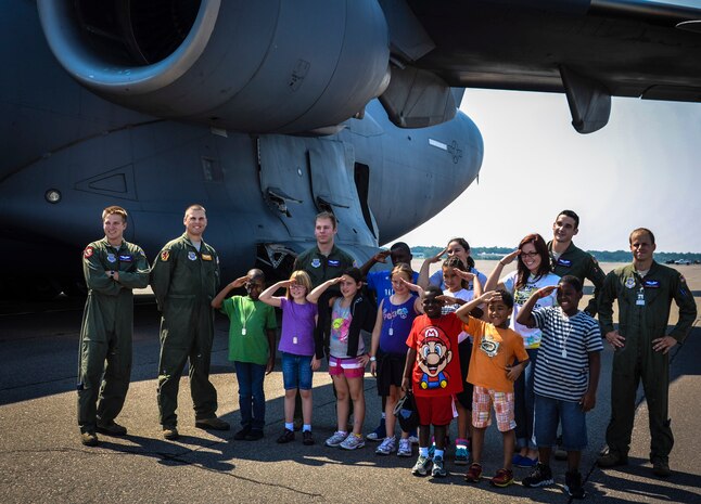 Joint Base Charleston – Weapons Station Youth Center children pose with loadmasters and pilots from the 15th and 16th Airlift Squadrons, 437th Airlift Wing, during the Children’s Deployment Camp, Aug. 14, at JB Charleston – Air Base, S.C. The camp included a tour of the C-17 Globemaster III, briefs from different agencies throughout the base and a military working dog demonstration. (U.S. Air Force photo by Senior Airman Anthony Hyatt)