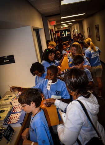 Children line up to go through the deployment-processing line during the Children’s Deployment Camp, Aug. 14, at Joint Base Charleston – Air Base, S.C. 628th Comptroller Squadron, Airman and Family Readiness Center, 628th Medical Group and 628th Air Base Wing Staff Judge Advocate Airmen volunteered to process the children through the line and pass out books and candy. (U.S. Air Force photo by Senior Airman Anthony Hyatt)
