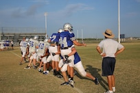 Members of the Joint Base San Antonio-Randolph High School Ro-Hawks football team run tackling drills during early morning practice Aug 13.  The football team started summer practice at Randolph , Aug 6. (U.S. Air Force photo by Rich McFadden) 