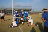 Members of the Joint Base San Antonio-Randolph High School Ro-Hawks football team run gauntlet drills during early morning practice Aug 13.  The football team started summer practice at Randolph , Aug 6. (U.S. Air Force photo by Rich McFadden) 