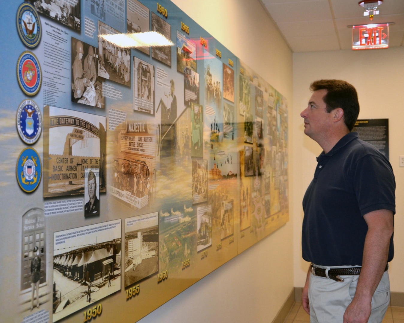 Peter Law, 502nd Air Base Wing historian, admires the new mural depicting San Antonio’s rich military history at the 502nd ABW headquarters on Joint Base San Antonio-Fort Sam Houston. (U.S. Army photo by Lori Newman)
