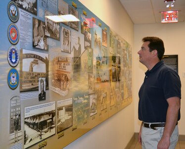 Peter Law, 502nd Air Base Wing historian, admires the new mural depicting San Antonio’s rich military history at the 502nd ABW headquarters on Joint Base San Antonio-Fort Sam Houston. (U.S. Army photo by Lori Newman)
