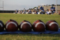 Joint Base San Antonio-Randolph High School football players help each other stretch before early morning practice Aug.13. The football team started summer practice Aig. 6. (U.S. Air Force photo by Rich McFadden)