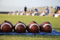 Joint Base San Antonio-Randolph High School football players help each other stretch before early morning practice Aug.13. The football team started summer practice Aig. 6. (U.S. Air Force photo by Rich McFadden)