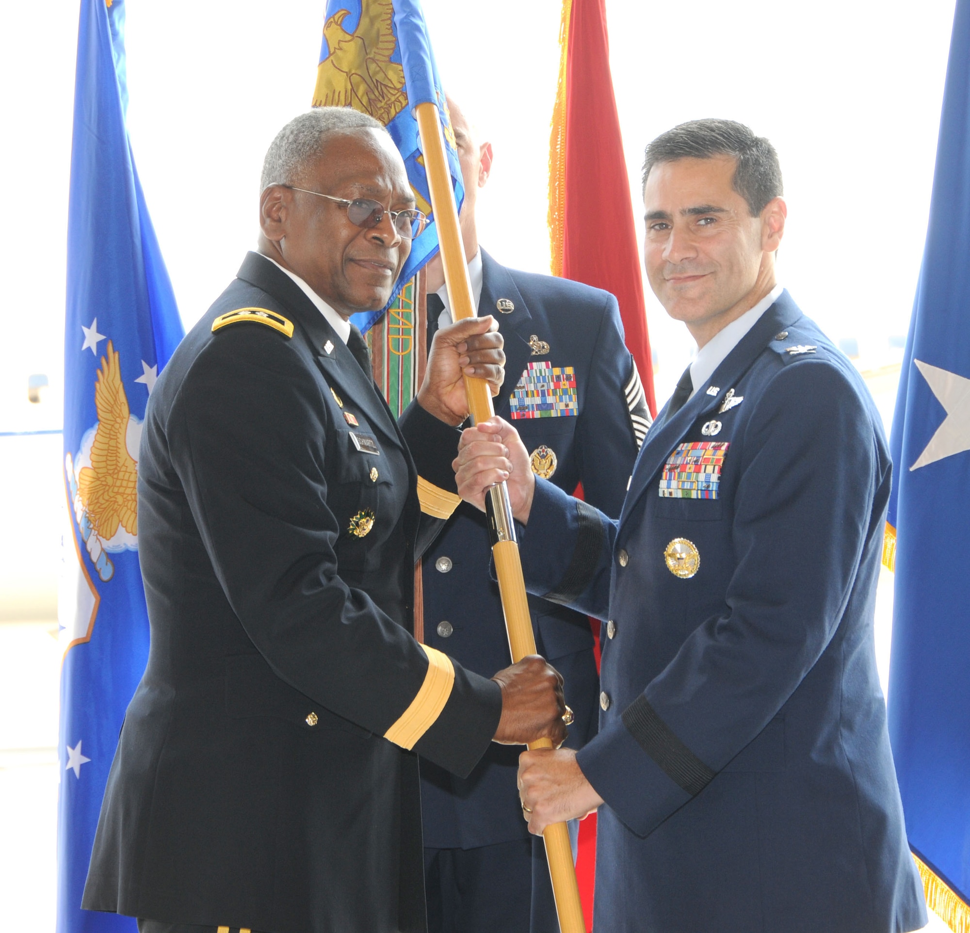 Brig. Gen. Marc Sasseville recieves the 113th Wing flag from Major General Errol Schwartz, Commanding General, D.C. National Guard, as General Sasseville assumes command of the 113th Wing from Brig. Gen. Jeffrey Johnson during the wing Change of Command ceremony, Joint Base Andrews, Md., Aug. 11, 2012.  (U.S. Air Force photo/Tech Sgt. Craig Clapper)  