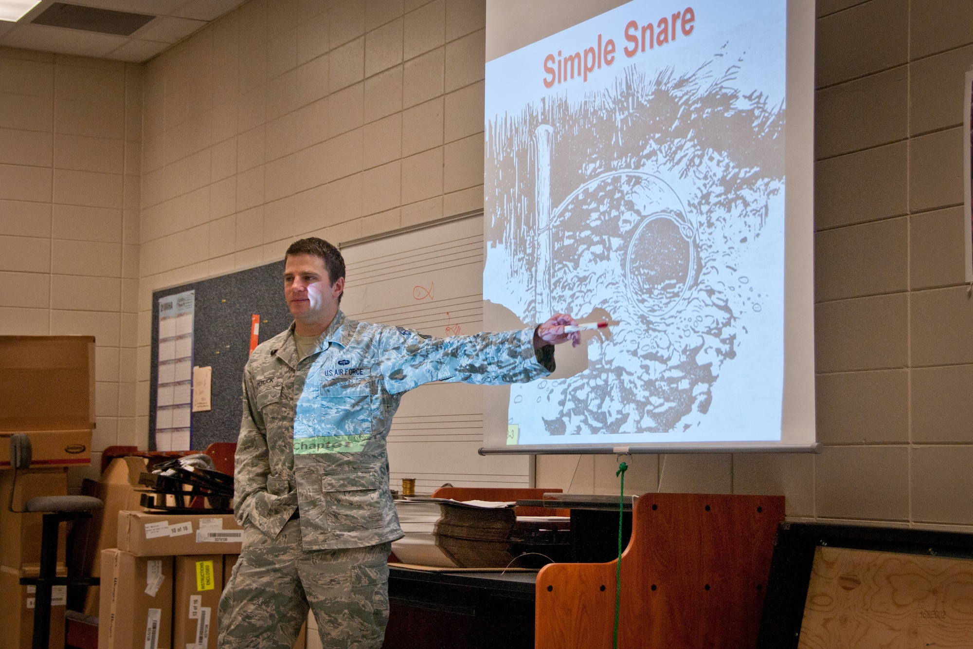 Air Force Junior Reserve Officers' Training Corps students from Woodbury and Park High Schools receive some specialized survival training from Staff Sgt. Scott Perlick, a Survival, Evasion, Resistance and Escape Specialist from the 934th Operational Support Squadron on August 8, as he explains how to make a simple snare in order to catch small prey for survival.  (U.S. Air Force Photo/Staff Sgt. Samantha Wagner)