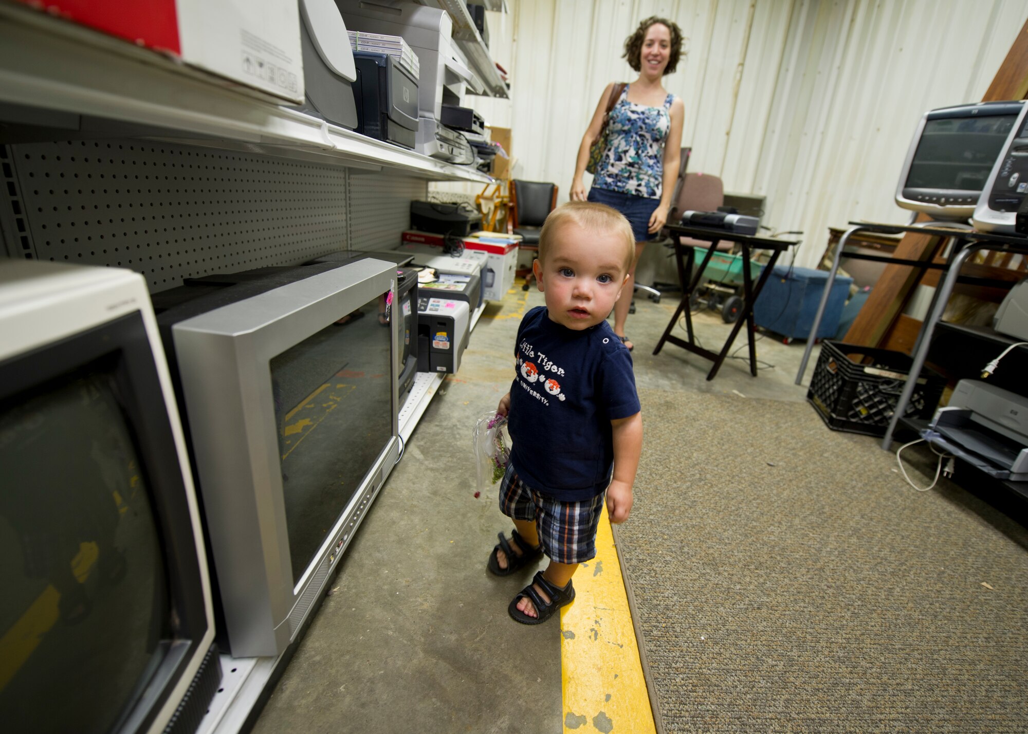 Wyatt [last name withheld due to operational security concerns], 1, son of Capt. Chad [last name withheld due to operational security concerns], 29th Attack Squadron, looks at items at the Holloman Air Force Base, N.M., Thrift Store Aug. 14. The Thrift Store, located inside Building 232 on Second St. and Connecticut Ave., provides Team Holloman members a cheaper avenue of acquiring new and gently-used items at a fraction of the cost of the item’s retail value. The store, open Tuesdays and Thursdays from 10 a.m. to 2 p.m. and the first Saturday of every month starting in October, also offers consignment deals to anyone looking to sell their items. All profits from the Thrift Store go to helping multiple organizations on base and in the Alamogordo community. (U.S. Air Force photo by Senior Airman Siuta B. Ika/ Released)