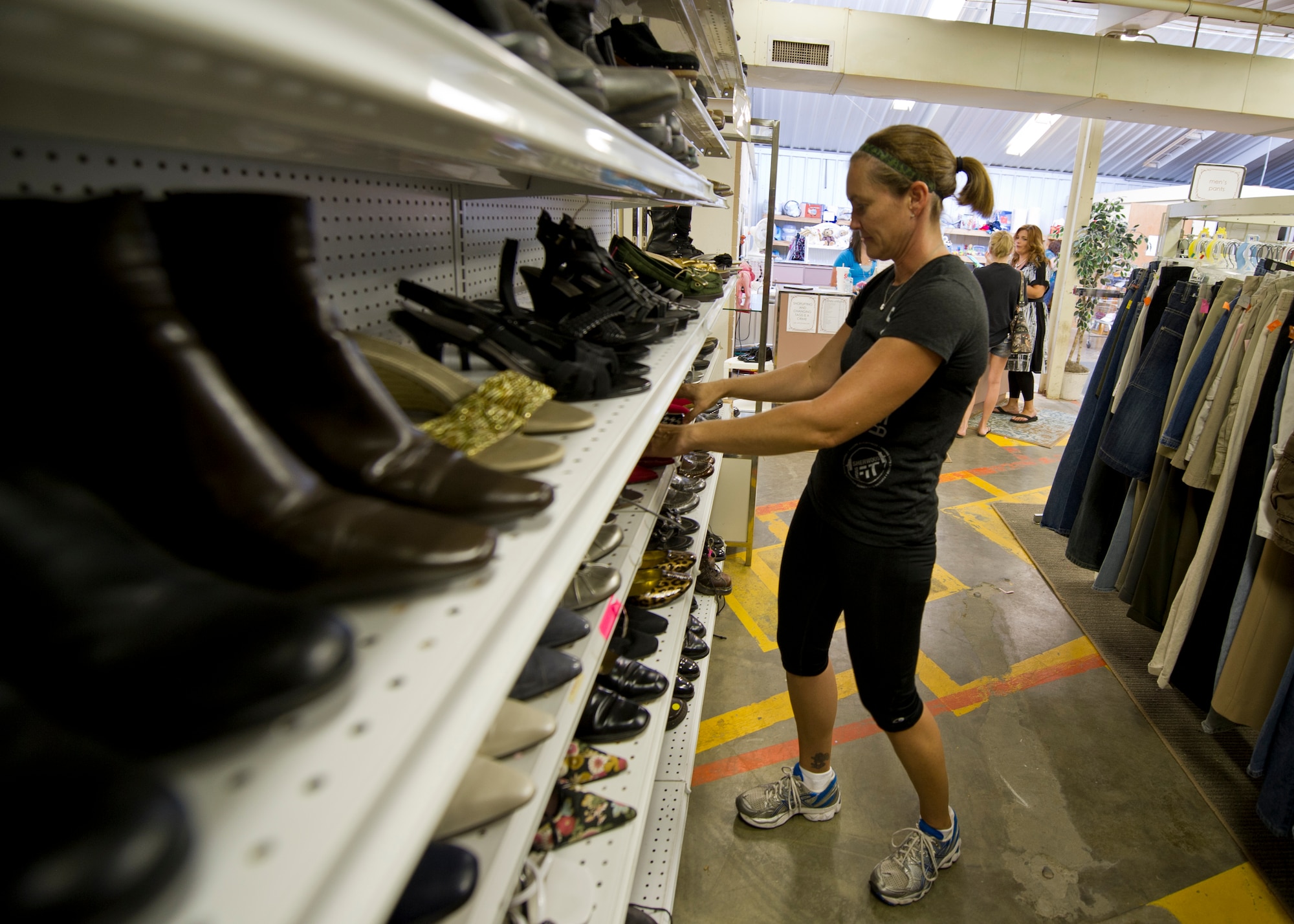Linda Penning, Holloman Officers’ Spouses’ Club president, organizes shoes for sale at the Holloman Air Force Base, N.M., Thrift Store Aug. 14. The Thrift Store, located inside Building 232 on Second St. and Connecticut Ave., provides Team Holloman members a cheaper avenue of acquiring new and gently-used items at a fraction of the cost of the item’s retail value. The store, open Tuesdays and Thursdays from 10 a.m. to 2 p.m. and the first Saturday of every month starting in October, also offers consignment deals to anyone looking to sell their items. All profits from the Thrift Store go to helping multiple organizations on base and in the Alamogordo community. (U.S. Air Force photo by Senior Airman Siuta B. Ika/ Released)