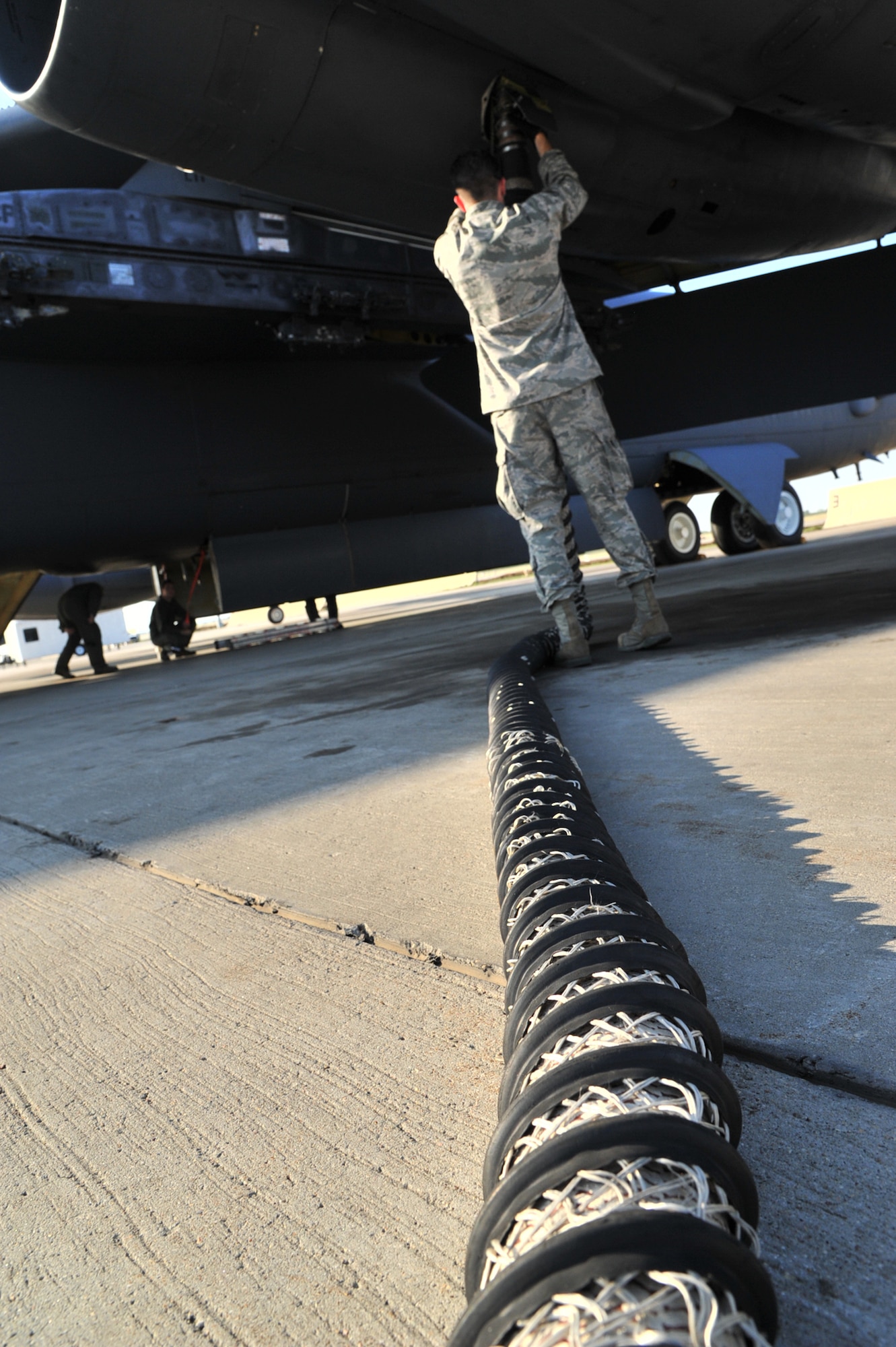 MINOT AIR FORCE BASE, N.D. – A crew chief from the 5th Aircraft Maintenance Squadron plugs an air cart into a B-52H Stratofortress prior to a mission here, Aug. 10. As part of Air Force Global Strike Command, crew chiefs work endlessly to preserve our nation’s security by providing combat-ready forces for nuclear deterrence and global strike operations.  (U.S. Air Force photo/Senior Airman Brittany Y. Auld) 