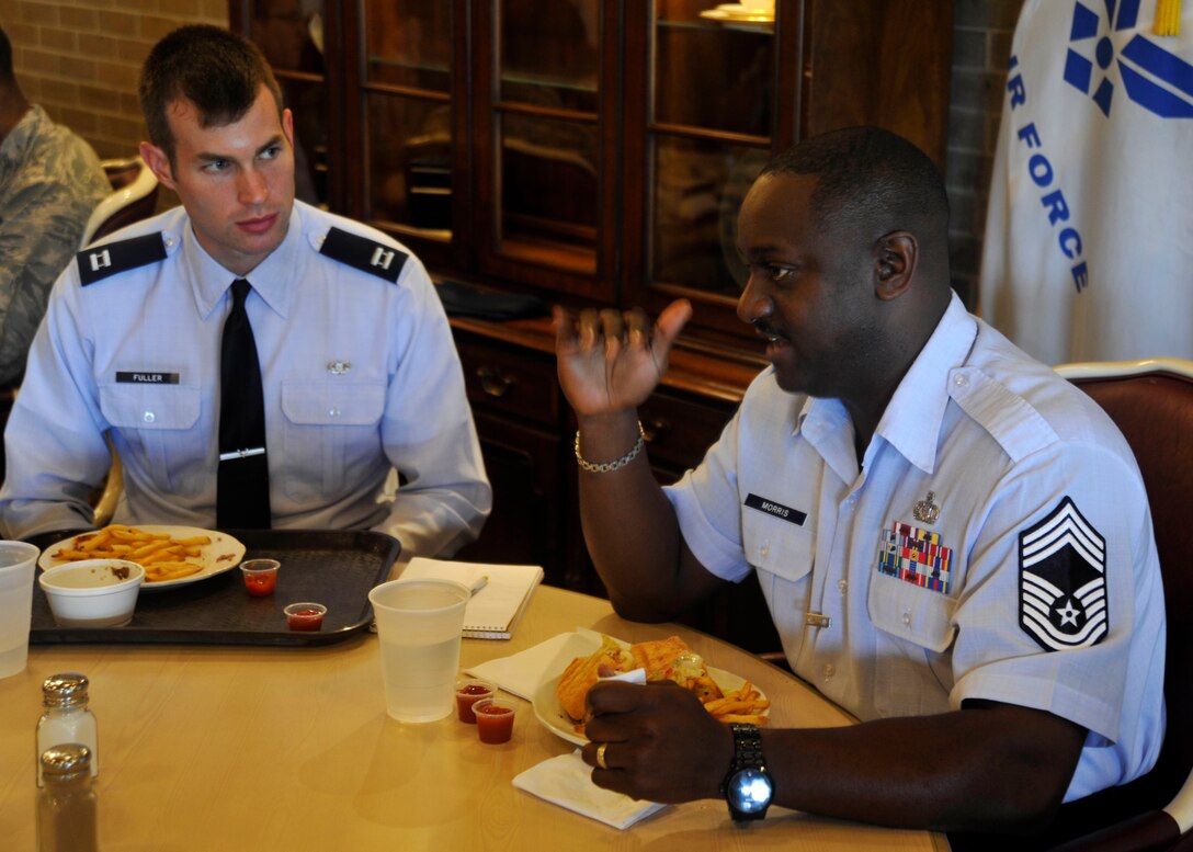 Chief Master Sgt. John Morris, chief of Andrews Regional Command post, right, gives his definition of sound leadership to Capt. Clayton Fuller, 11th Wing assistant staff judge advocate, during a professional development luncheon at the Courses at Andrews Aug. 7, 2012. The luncheon provided CGOC members with an enlisted perspective on various work-related topics. (U.S. Air Force photo/Senior Airman Lindsey A. Porter) 
