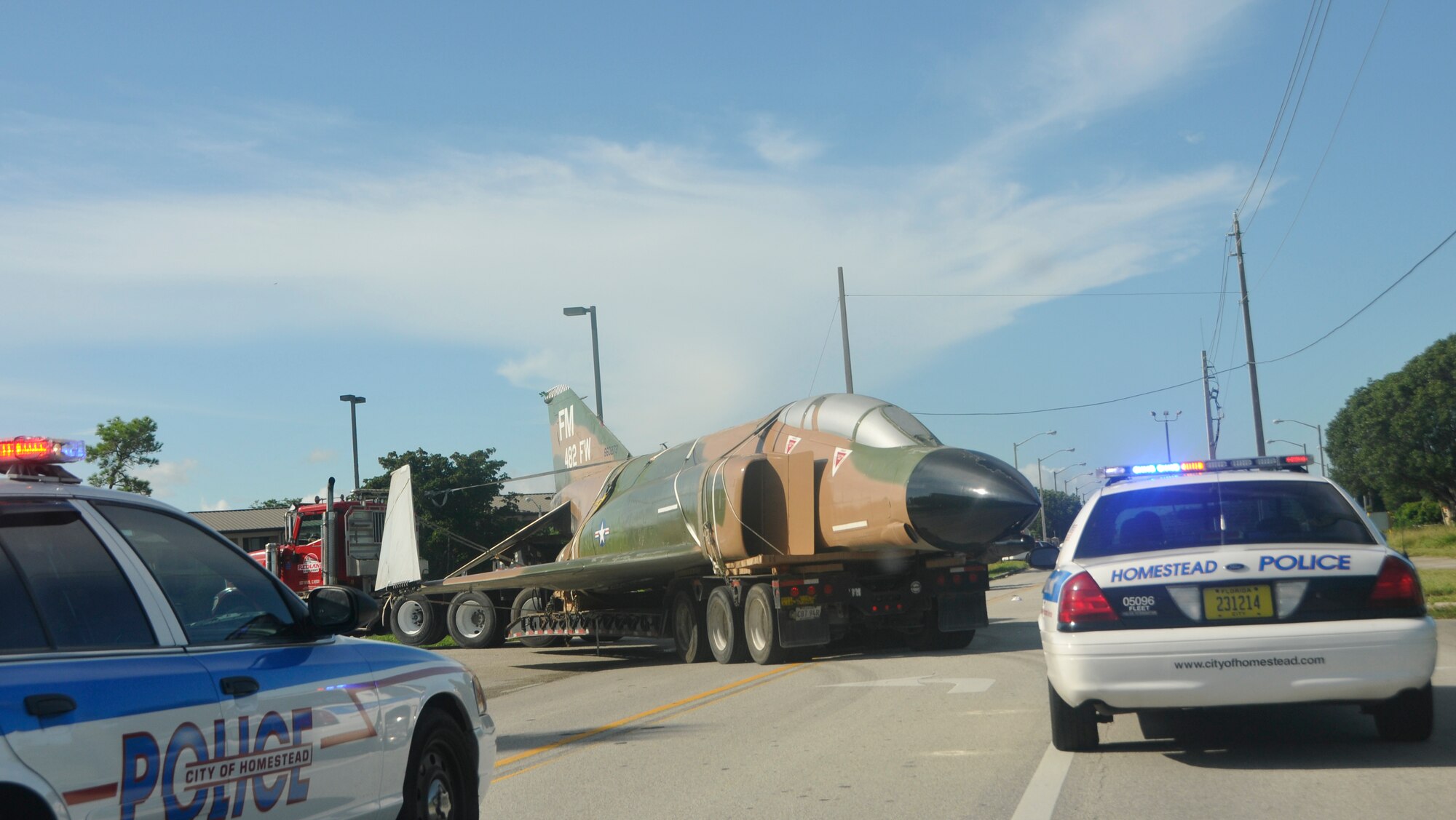 Escorted by Homestead Police, Air Force Reservist and local contractors transport the F-4 from Homestead, Saturday morning Aug. 4.  The Jet was removed from its former location on U. S. 1 to be painted. 
