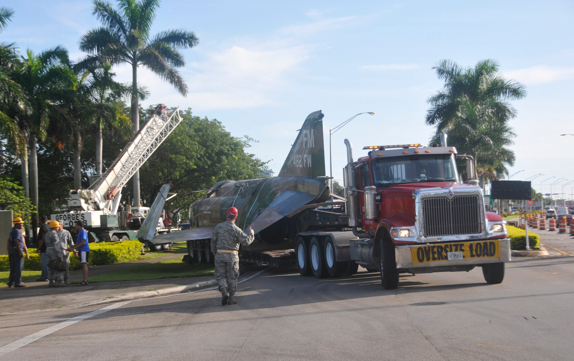 Local contractors pull away from Homestead's F-4's viewing site while transporting the jet to Homestead Air Reserve  Base, Saturday morning Aug. 4. The jet will undergo a 3 month process consisting of  repairs and repainting of the jet. 