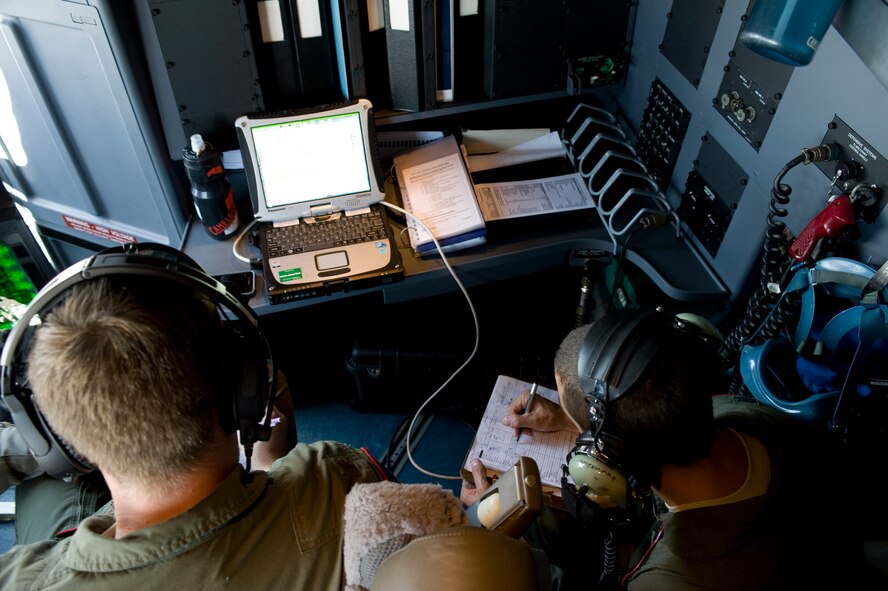 U.S. Air Force Maj. Daniel Hilferty, 317th Operations Support Squadron, left, and Capt. Joshua Linden, 40th Airlift Squadron, right, review Joint Precision Airdrop System (JPADS) data prior to an airdrop during a training mission Aug. 14, 2012, at Fort Hood, Texas.  JPADS is a cargo parachute system that incorporates an onboard global positioning system able to guide the cargo with pinpoint accuracy to a designated drop zone. JPADS also allows cargo to be dropped from higher attitudes, allowing aircraft to safely avoid enemy ground fire. (U.S. Air Force photo by Staff Sgt. Richard P. Ebensberger/ Released)