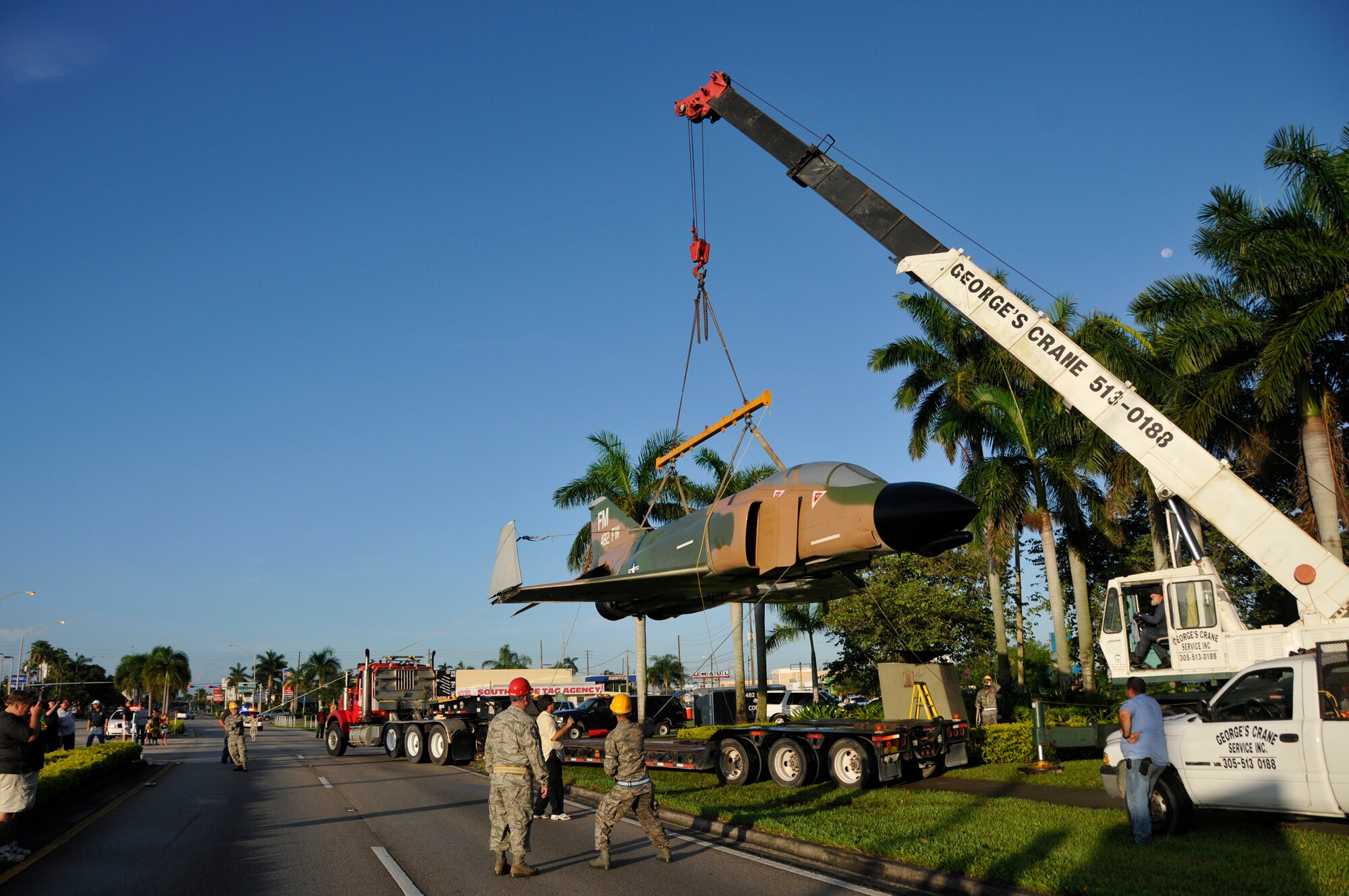 Contractors and Air Force Reservist lower Homesteads F-4 onto a trailer for transport, Saturday morning Aug. 4. The transportation process of the jet took over five hours to complete. 