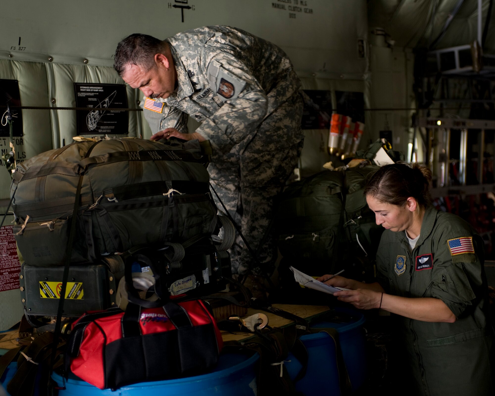 U.S. Army Sgt. 1st Class Ray Mendez, 294th Quartermaster Company, left, and U.S. Air Force Staff Sgt. Janet Freshley, 317th Operations Support Squadron, check over a cargo parachute equipped with Joint Precision Airdrop System (JPADS) on a C-130J Super Hercules assigned to the 317th Airlift Group, prior to an airdrop training mission Aug.  14, 2012, at Fort Hood, Texas.  JPADS is a cargo parachute system that incorporates an onboard global positioning system able to guide the cargo with pinpoint accuracy to a designated drop zone. JPADS also allows cargo to be dropped from higher attitudes, allowing aircraft to safely avoid enemy ground fire. (U.S. Air Force photo by Staff Sgt. Richard P. Ebensberger/ Released)