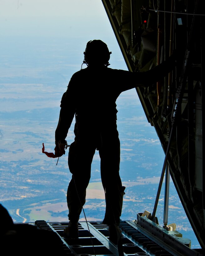 U.S. Air Force Airman 1st Class Korey King, 40th Airlift Squadron, prepares to release a wind sonde from a C-130J Super Hercules assigned to the 317th Airlift Group prior to an airdrop training mission Aug. 14, 2012, at Dyess Air Force Base, Texas.  This wind sonde device is part of Joint Precision Airdrop System (JPADS), and is released at high altitudes over a drop zone to measure the wind prior to an actual cargo drop.  JPADS is a cargo parachute system that incorporates an onboard global positioning system able to guide the cargo with pinpoint accuracy to a designated drop zone. JPADS also allows cargo to be dropped from higher attitudes, allowing aircraft to safely avoid enemy ground fire. (U.S. Air Force photo by Staff Sgt. Richard P. Ebensberger/ Released)