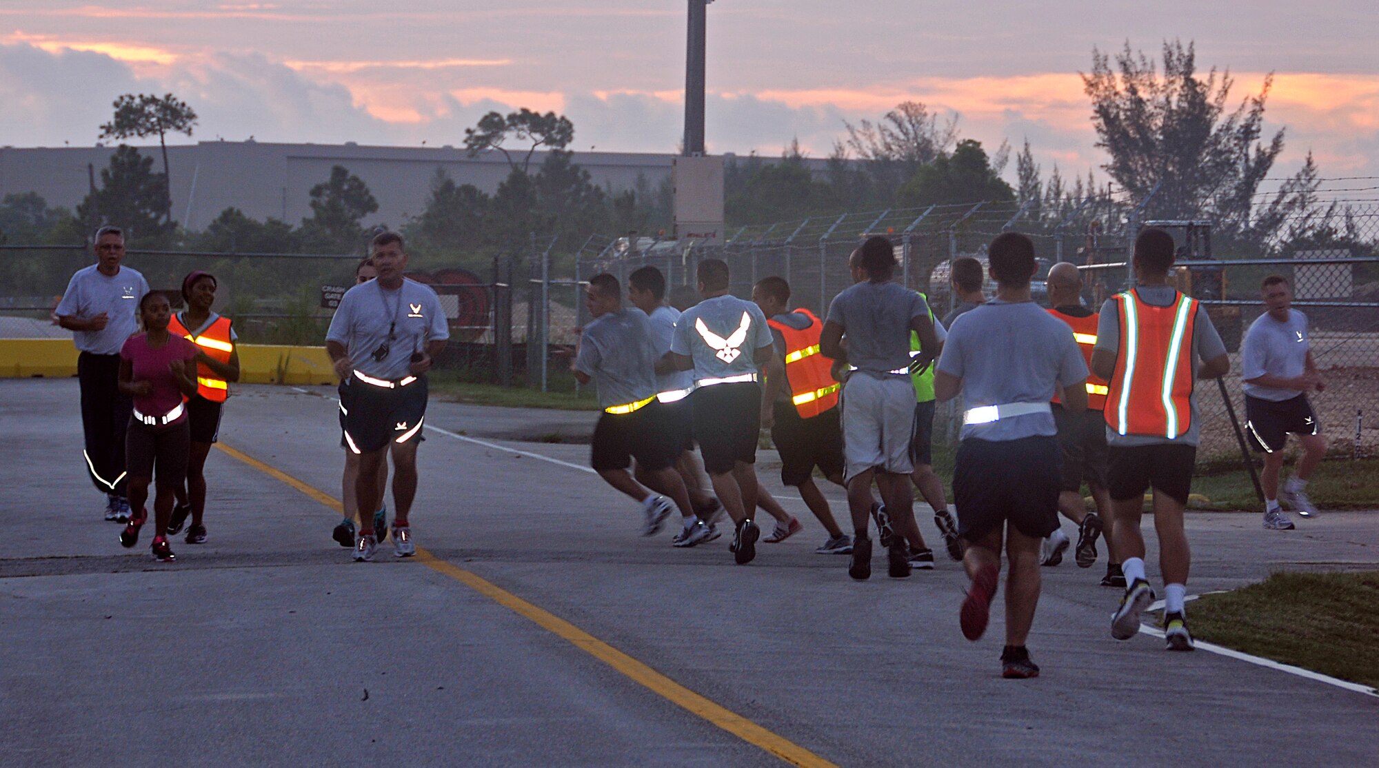 Instructors and trainees with the Development and Training Flight make a turn on their early-morning run at Homestead Air Reserve Base, Fla., Aug. 12. The Development and Training Flight is a group of trainees who wish to prepare themselves before making their way to basic military training and technical school. The goal of the development and training flight is to reduce the number of seats lost in basic military training and technical school by ensuring all trainees are better prepared for the Air Education and Training Command environment. (U.S. Air Force photo/Senior Airman Jaimi Upthegrove)