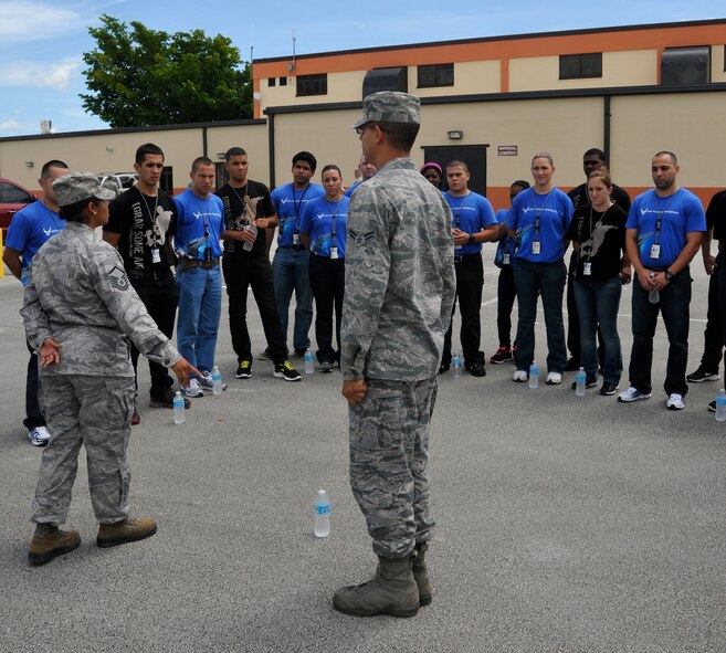 Master Sgt. Carmen Martinez, Development and Training Flight assistant program manager, instructs Development and Training Flight trainees on proper facing movement technique at Homestead Air Reserve Base, Fla., Aug. 12. The Development and Training Flight is a group of trainees who wish to prepare themselves before making their way to basic military training and technical school. The goal of the development and training flight is to reduce the number of seats lost in basic military training and technical school by ensuring all trainees are better prepared for the Air Education and Training Command environment. (U.S. Air Force photo/Senior Airman Jaimi Upthegrove)