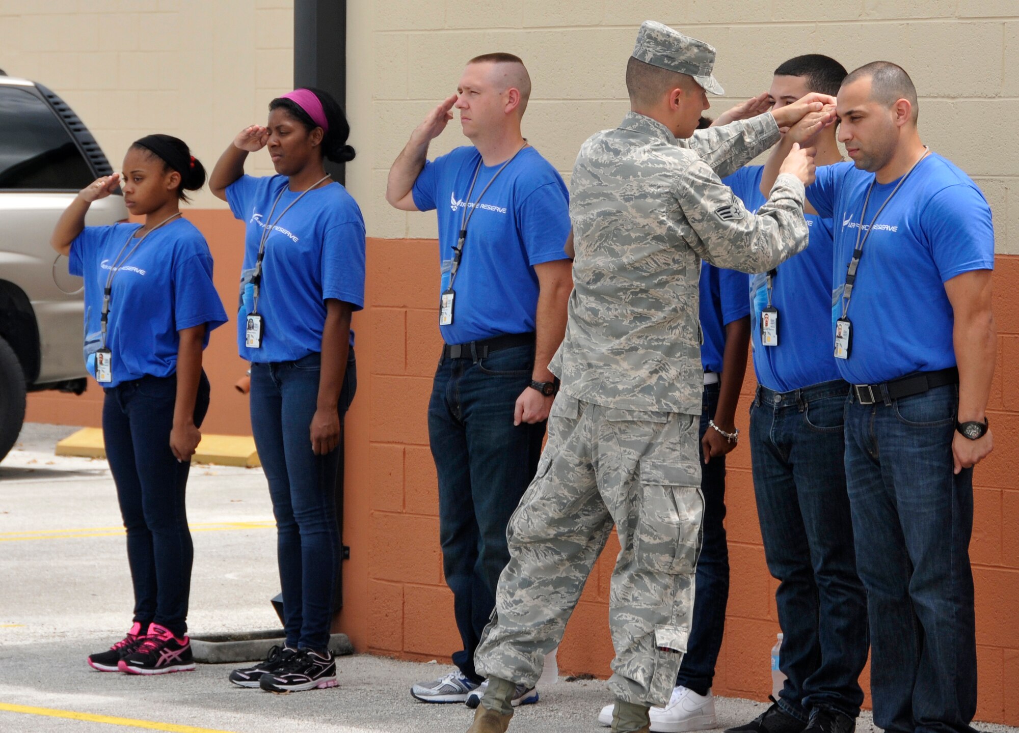 Senior Airman Heriberto Roman Perez, Development and Training Flight volunteer instructor, instructs Development and Training Flight trainees on the proper way to render a salute at Homestead Air Reserve Base, Fla., Aug. 12. The Development and Training Flight is a group of trainees who wish to prepare themselves before making their way to basic military training and technical school. The goal of the development and training flight is to reduce the number of seats lost in basic military training and technical school by ensuring all trainees are better prepared for the Air Education and Training Command environment. (U.S. Air Force photo/Senior Airman Jaimi Upthegrove)