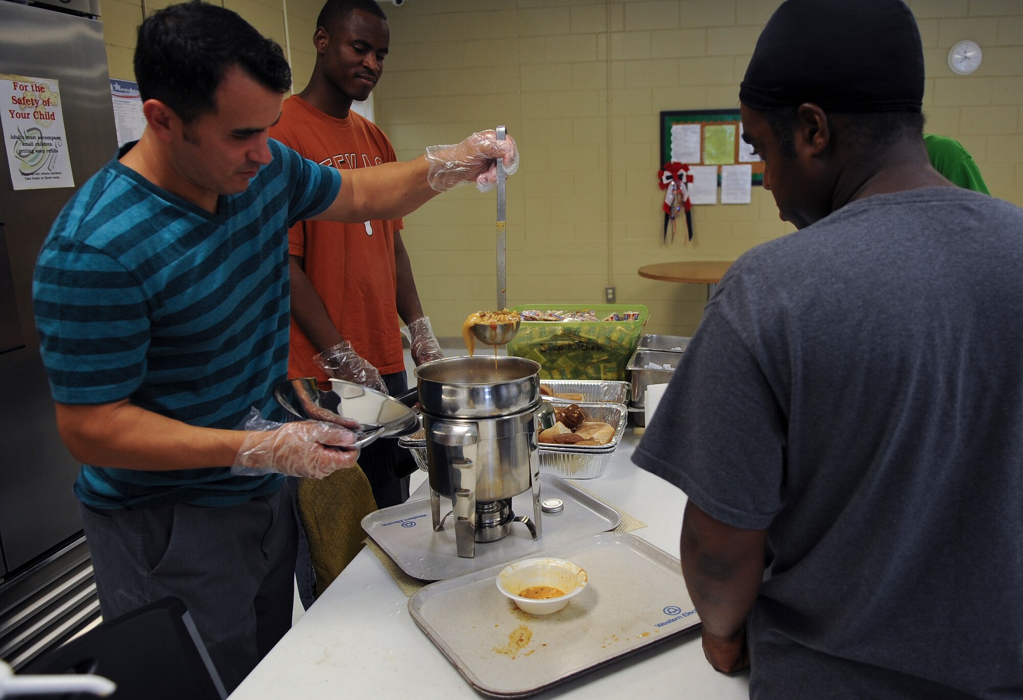 U.S. Air Force Tech. Sgt. Steven Haro, member of the Moody Air Force Base Chapter 460 Air Force Sergeants Association, serves soup while volunteering at the Community Soup Kitchen in Valdosta, Ga., Aug. 14, 2012. AFSA not only participated in the soup kitchen but they arrange recruiting events as well as providing donations to the Air Force Ball. (U.S. Air Force photo by Airman 1st Class Olivia Dominique/Released)