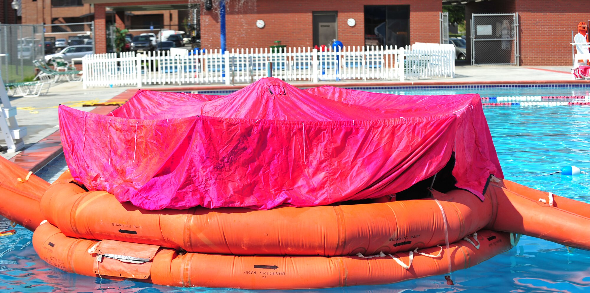 Aircrew members simulate living on a 20-man life raft during a water survival training course at Moody Air Force, Base, Ga., Aug. 9, 2012. Seven Airmen took part in the class and learn how to survive on all three different life rafts along with parachute disentanglement, and shallow water egress trainer chair. (U.S. Air Force photo by Staff Sgt. Stephanie Mancha/Released)
