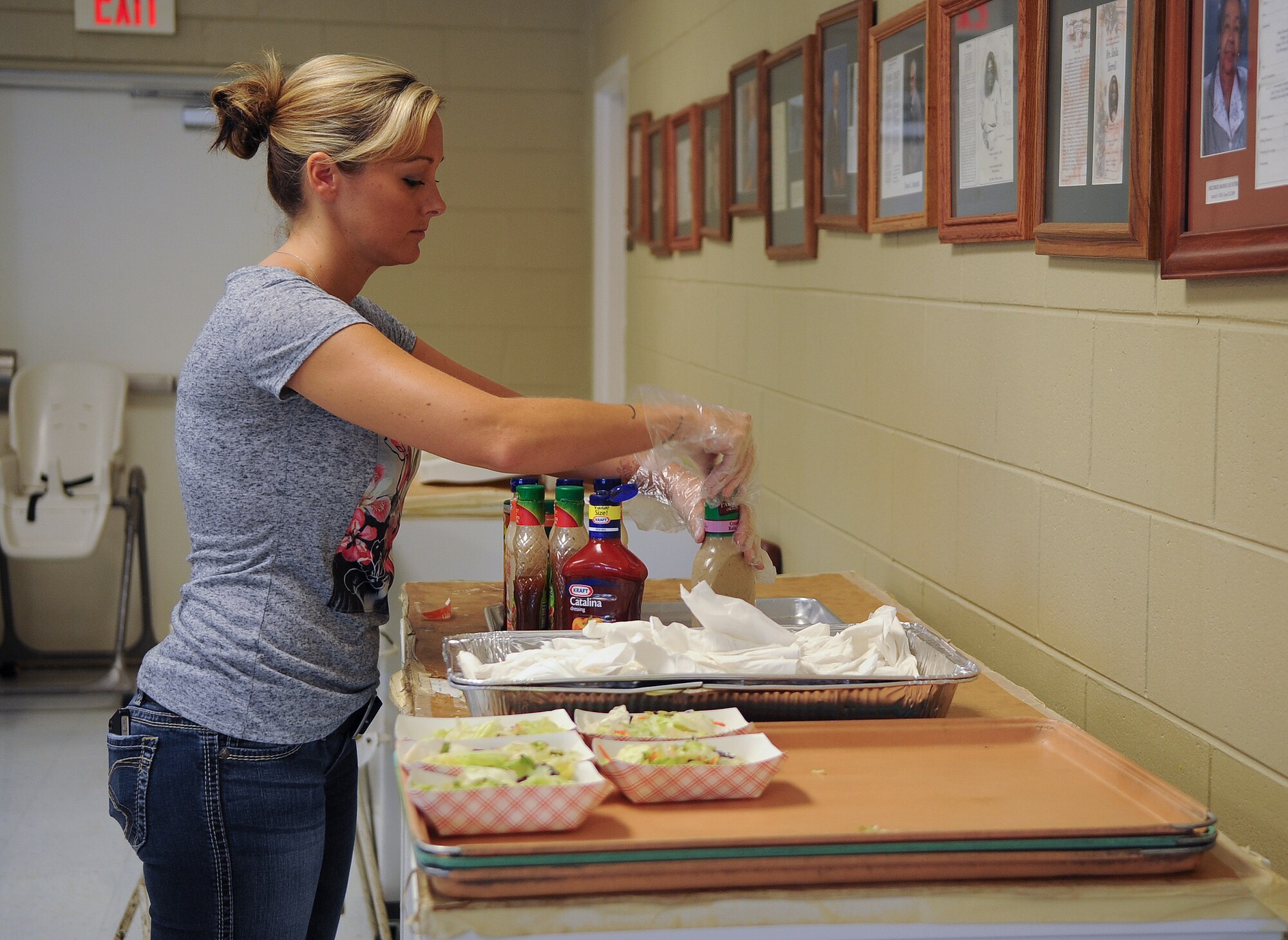 U.S. Air Force Tech Sgt. Jacqueline Haro, member of the Moody Air Force Base Chapter 460 Air Force Sergeants Association, arranges salad dressings while helping out at the Community Soup Kitchen in Valdosta, Ga., Aug. 14, 2012. AFSA is a non-profit organization that represents the personal and professional interest of all enlisted members, active, veteran and retired, of the Air Force. (U.S. Air Force photo by Airman 1st Class Olivia Dominique/Released)