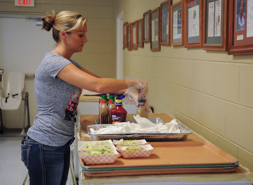 U.S. Air Force Tech Sgt. Jacqueline Haro, member of the Moody Air Force Base Chapter 460 Air Force Sergeants Association, arranges salad dressings while helping out at the Community Soup Kitchen in Valdosta, Ga., Aug. 14, 2012. AFSA is a non-profit organization that represents the personal and professional interest of all enlisted members, active, veteran and retired, of the Air Force. (U.S. Air Force photo by Airman 1st Class Olivia Dominique/Released)