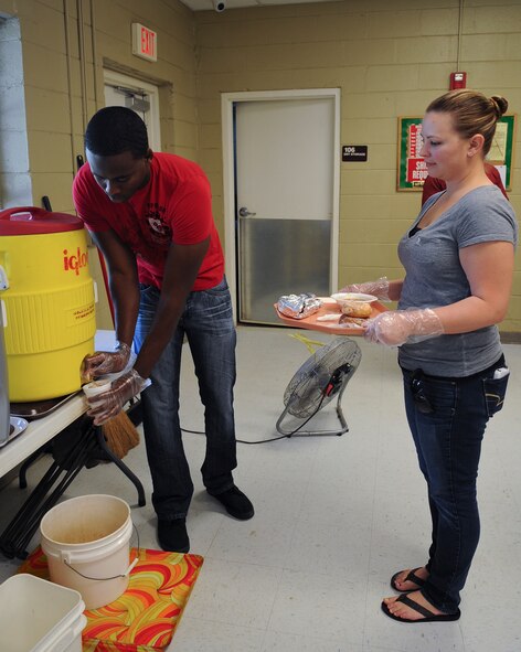 U.S. Air Force Gregory Hoogdorp, member of the Moody Air Force Base Chapter 460 Air Force Sergeants Association, fills up a beverage while helping out at the Community Soup Kitchen in Valdosta, Ga., Aug. 14, 2012. This was the first time AFSA volunteered at the soup kitchen and has planned to continue. (U.S. Air Force photo by Airman 1st Olivia Dominique/Released)