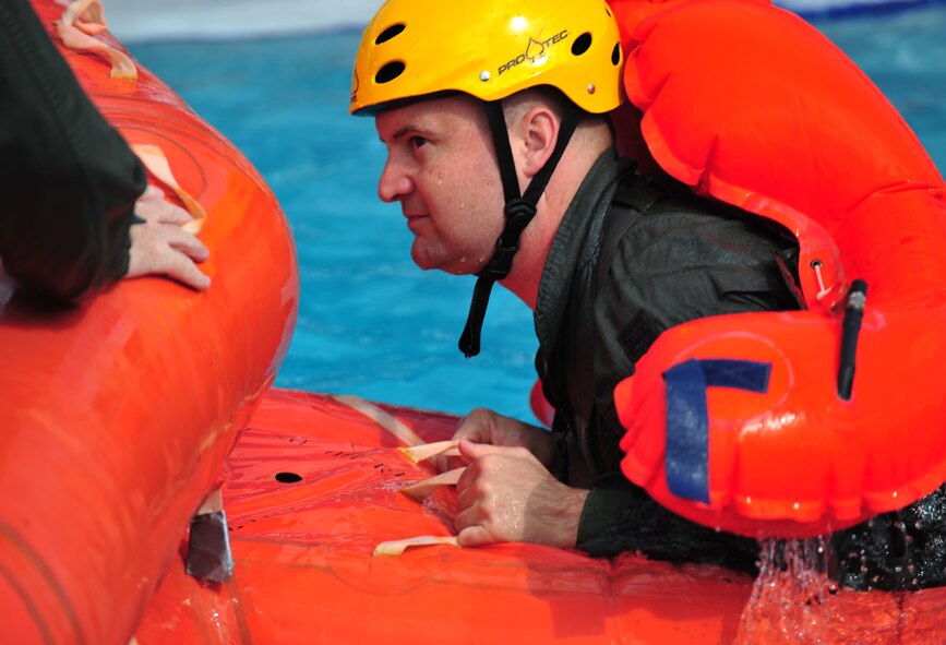 U.S. Air Force Maj. Marcus Snyder, 23d Aerospace Medicine Squadron flight surgeon, practices the proper way to board a life raft during the water survival training course at Moody Air Force Base, Ga., Aug. 9, 2012. Water survival training can save Airmen’s lives by preparing them to survive using the equipment that is on them if they are put into a survival situation.  (U.S. Air Force photo by Staff Sgt. Stephanie Mancha/Released)
