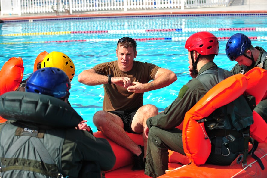 U.S. Air Force Tech. Sgt. Daniel Daubert, 347th Operations Support Squadron survival evasion resistance and escape specialist, teaches aircrew members what to do once they board a life raft during the water survival training course at Moody Air Force Base, Ga., Aug. 9, 2012. Water survival training keep aircrew member’s current on operational readiness needed to survive and evade capture in the event they have to eject over water.   (U.S. Air Force photo by Staff Sgt. Stephanie Mancha/Released)
