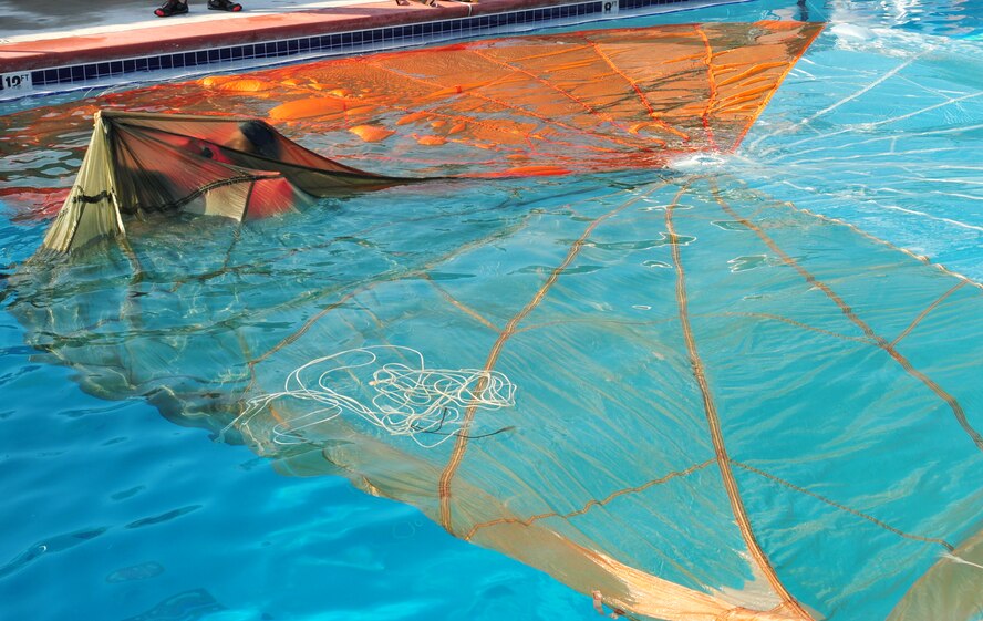 An aircrew member from Moody Air Force Base, Ga., practices disentangling from the parachute during a refresher water survival training course Aug. 9, 2012. Aircrew members have to attend water survival training every 36 months to stay current on their training. (U.S. Air Force photo by Staff Sgt. Stephanie Mancha/Released)
