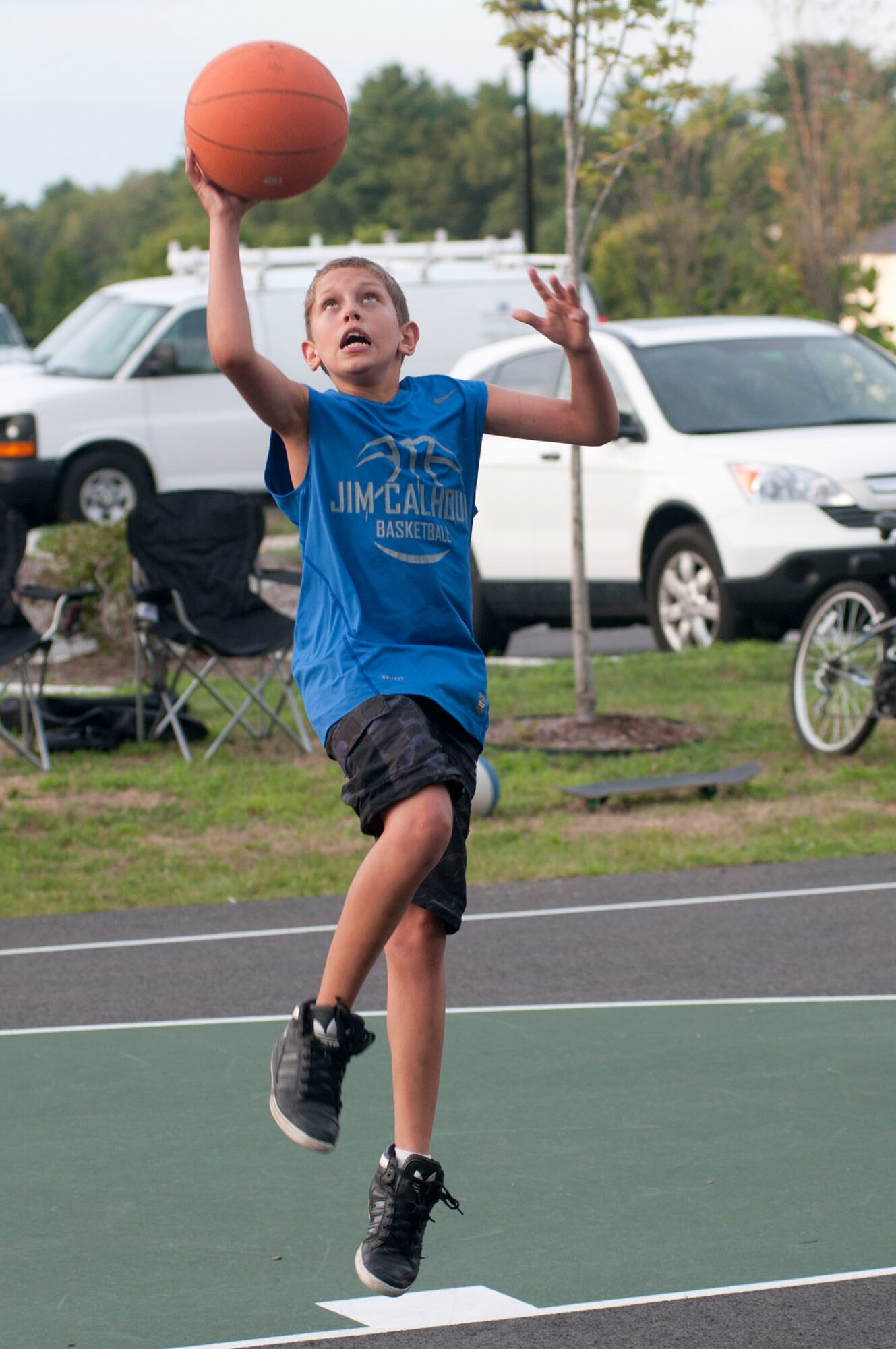 HANSCOM AIR FORCE BASE, Mass. - Reggie Cossingham goes up for a layup during the Youth Center's “summah” hoops program Aug. 14 at the recreation area in base housing. Youth meet each Tuesday between 6 to 9 p.m. to play pick-up basketball. (U.S. Air Force photo by Mark Wyatt)