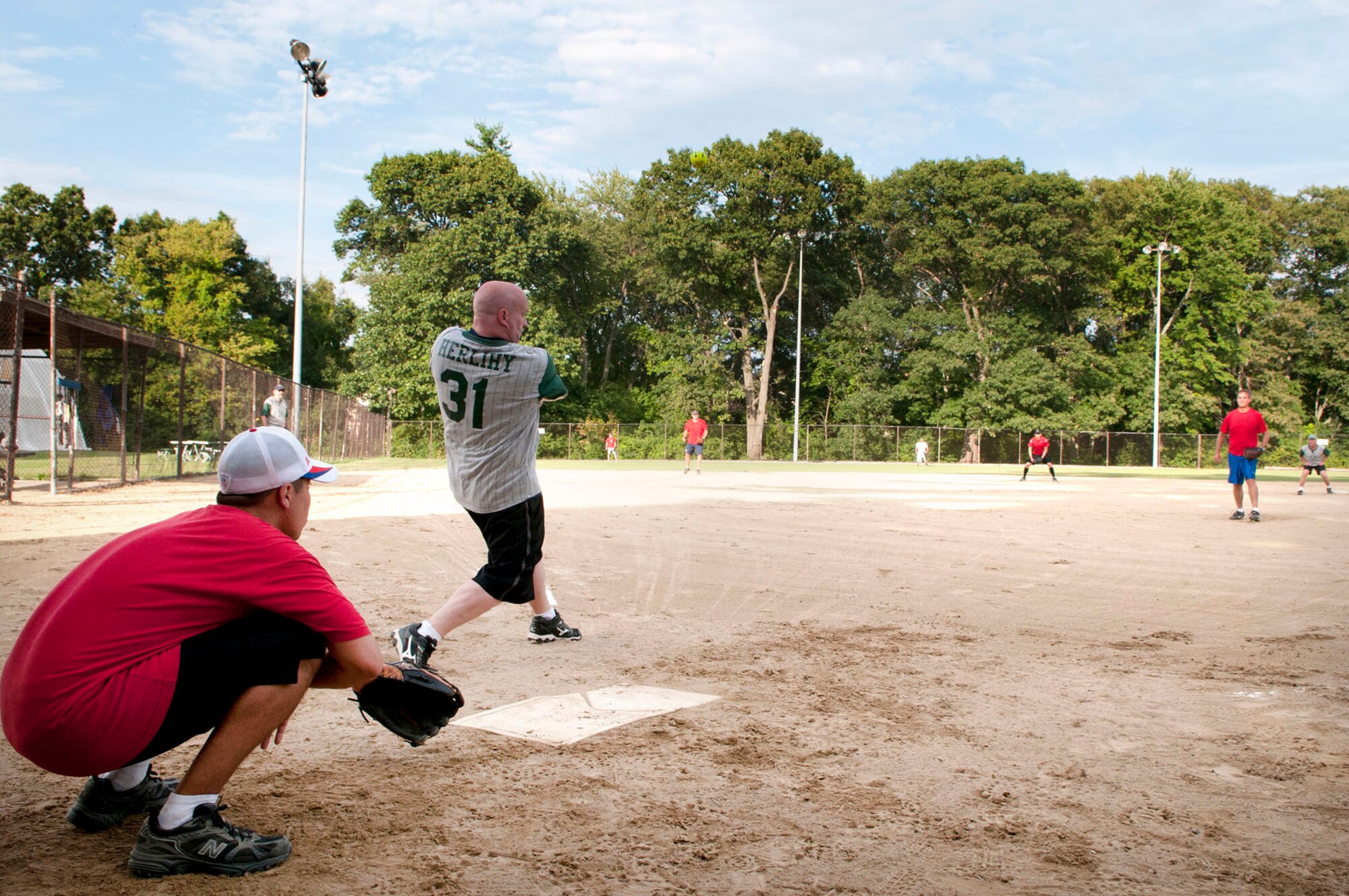 HANSCOM AIR FORCE BASE, Mass. – Mark Herlihy, a member of the HSIB recreational softball team, takes a swing at a pitch during the team's final regular season game against HS on Aug. 14. HS went on to win the game by a score of 16 to 11. Playoffs will begin soon for the recreation league. (U.S. Air Force photo by Mark Wyatt)