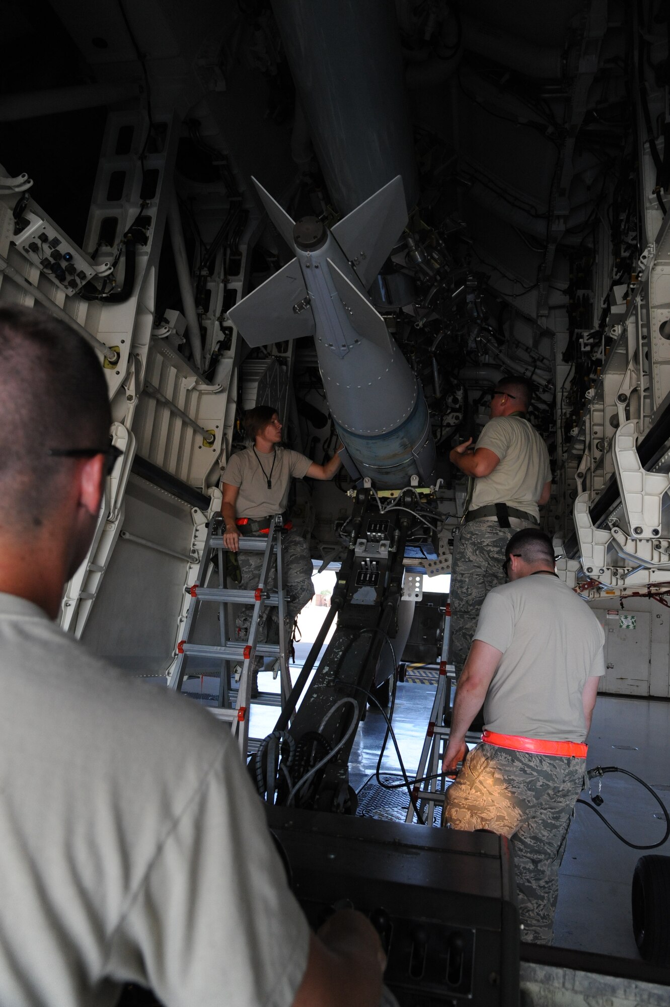 WHITEMAN AIR FORCE BASE, Mo.—  The weapons load crew team, loads a GBU-31v1 on a rotary launcher assembly, during a training exercise, Aug. 7. The team is assigned to the 13th Bomb Squadron. (U.S. Air Force photo/ Senior Airman Montse Belleau)