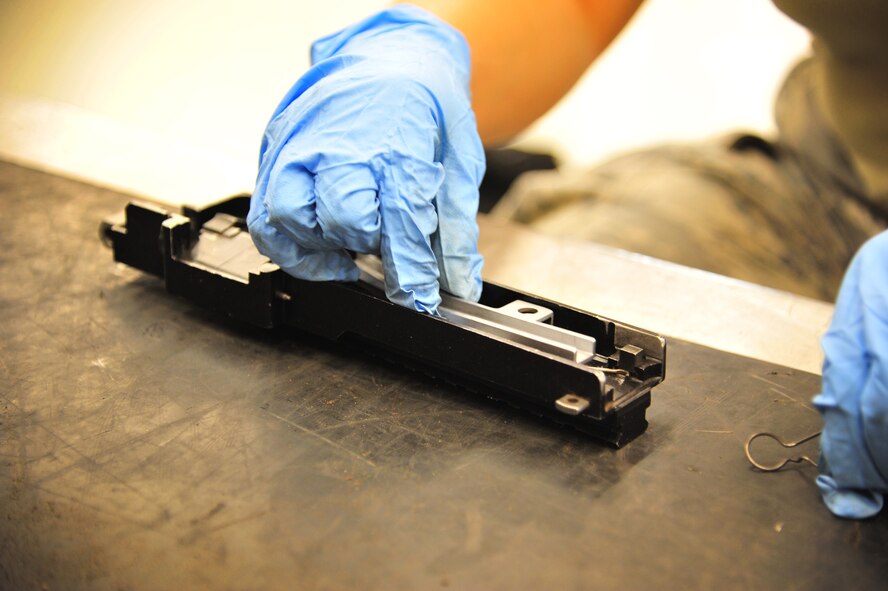 U.S. Air Force Senior Airman Melissa Moreno, 27th Special Operations Maintenance Squadron, cleans a weapon component in the armament shop at Cannon Air Force Base, N.M., Aug. 14, 2012. Armament troops handle disassembling, cleaning, lubing and inspecting weaponry for their assigned aircraft at Cannon. (U.S. Air Force photo/Airman 1st Class Alexxis Pons Abascal)  