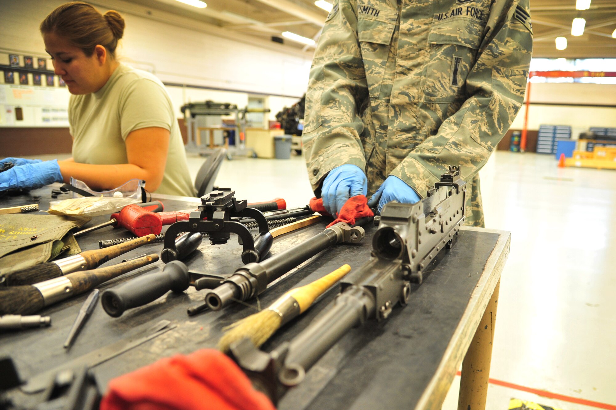 U.S. Air Force Senior Airman Brad Smith, 27th Special Operations Maintenance Squadron, works with several weapon components in the armament shop at Cannon Air Force Base, N.M., Aug. 14, 2012. Armament troops handle disassembling, cleaning, lubing and inspecting weaponry for their assigned aircraft at Cannon. (U.S. Air Force photo/Airman 1st Class Alexxis Pons Abascal)  
