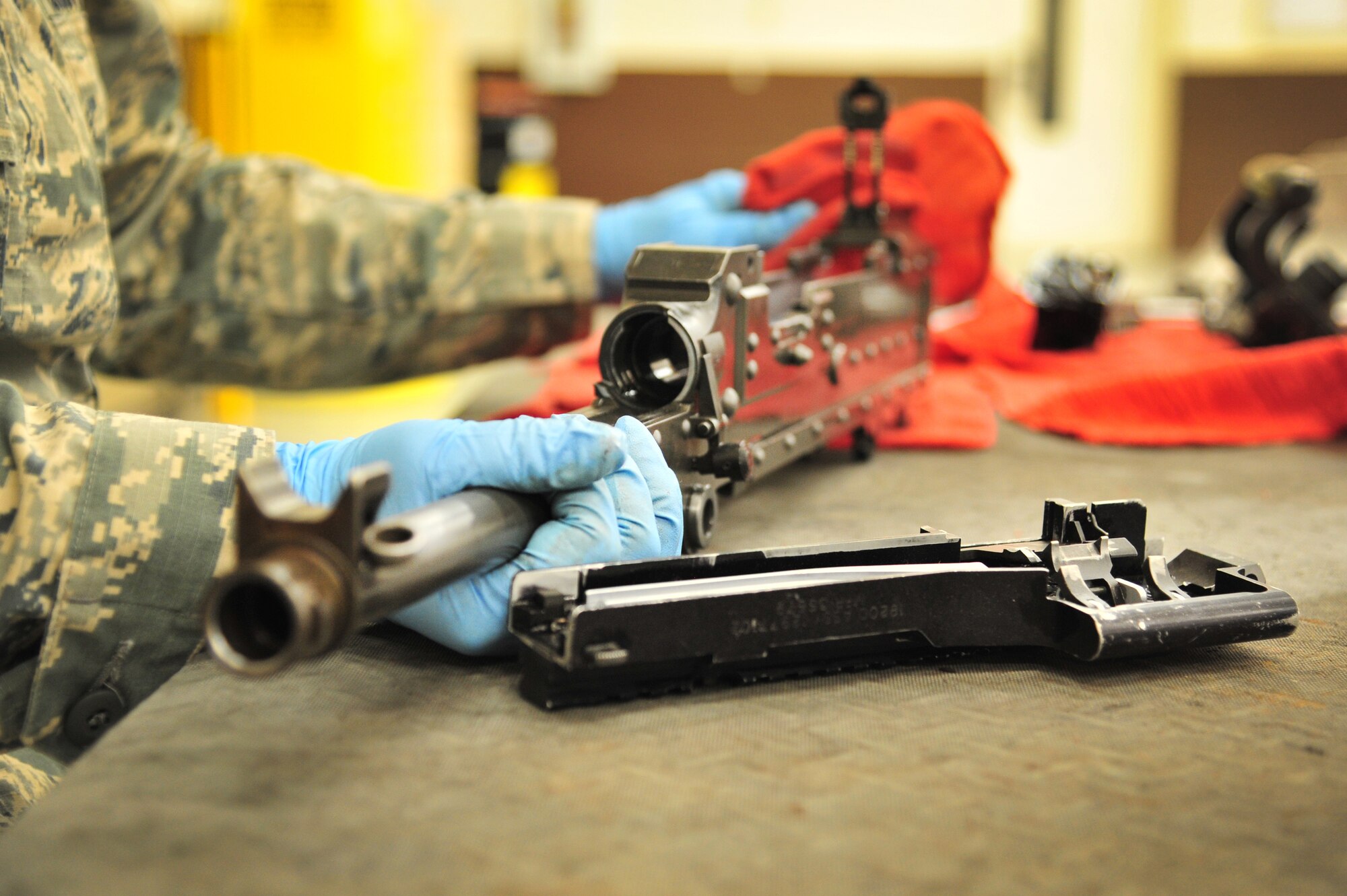 U.S. Air Force Senior Airman Tara Robinson, 27th Special Operations Maintenance Squadron, cleans a weapon in the armament shop at Cannon Air Force Base, N.M., Aug. 14, 2012. Armament troops handle disassembling, cleaning, lubing and inspecting weaponry for their assigned aircraft at Cannon. (U.S. Air Force photo/Airman 1st Class Alexxis Pons Abascal)  