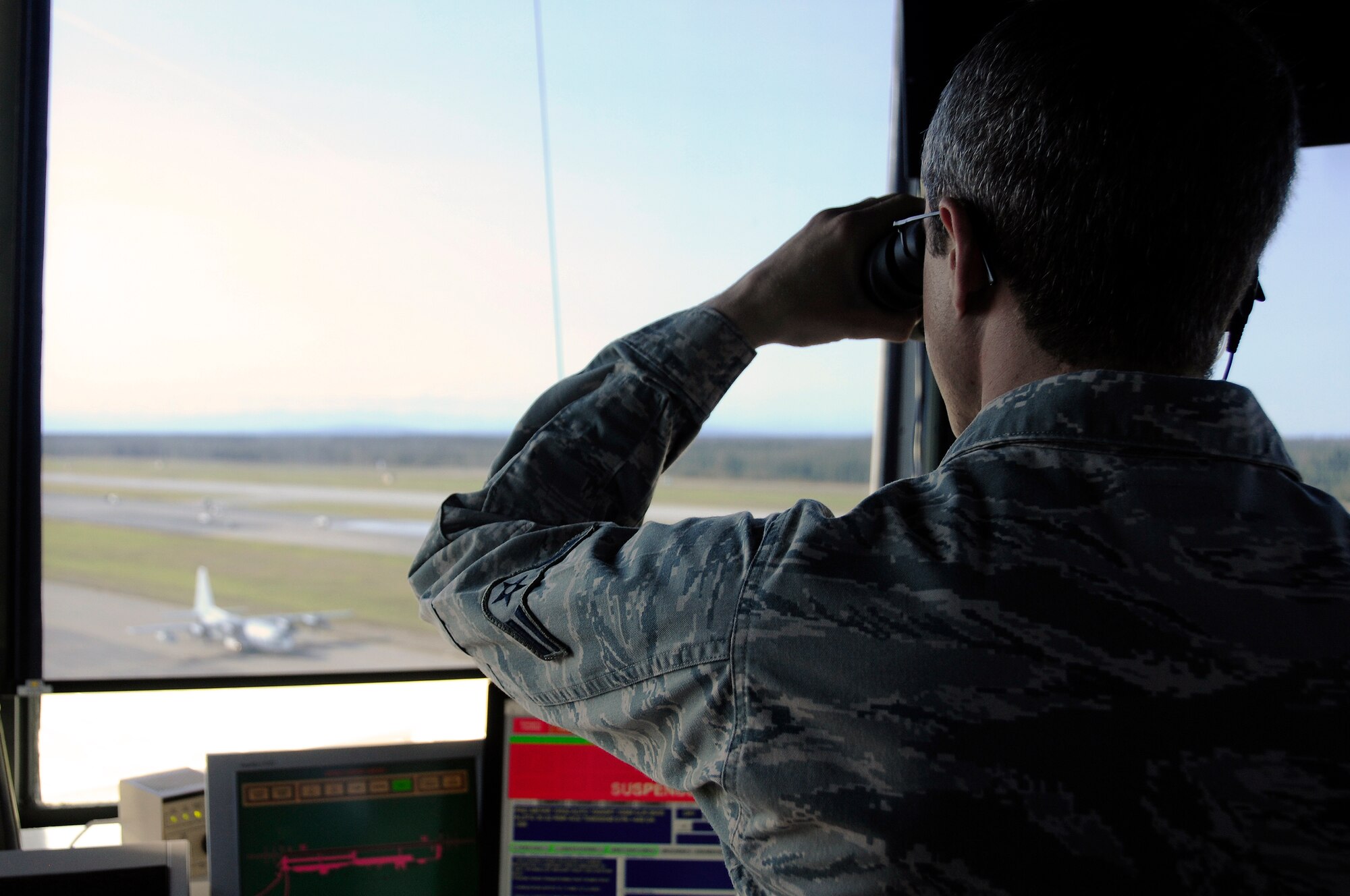 U.S. Air Force Airman 1st Class Scott Larson, 354th Operations Support Squadron air traffic controller, watches the flight line as a C-130 Hercules taxis August 10, 2012, Eielson Air Force Base, Alaska. Air traffic controllers provide expeditious airflow through Eielson’s airspace and traffic patterns to ensure pilots’ safety. (U.S. Air Force photo/Airman 1st Class Zachary Perras)