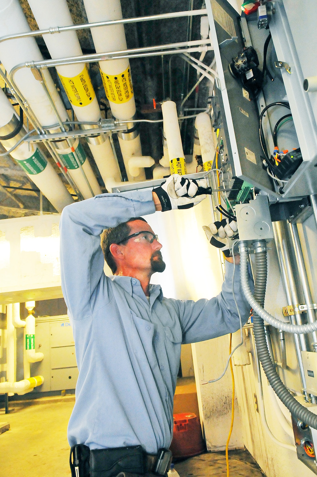 Barry White,78th Civil Engineer Squadron HVAC shop, works on the control panel at the Fitness Center. (U. S. Air Force photo/Sue Sapp)