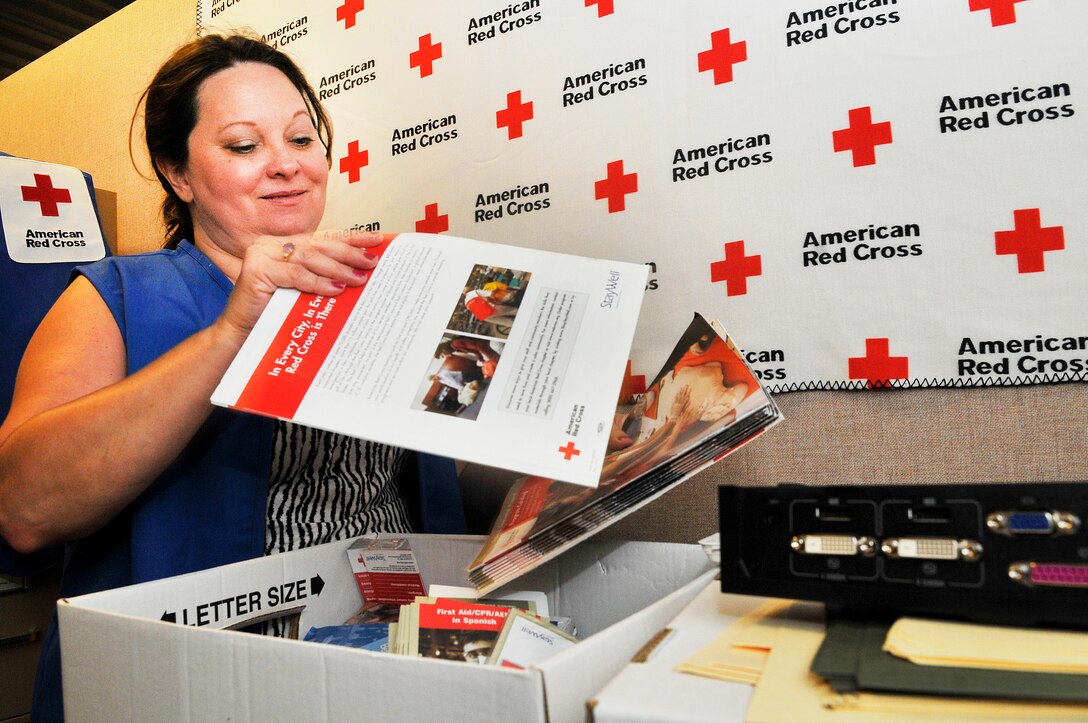 Judy Dienst unpacks office materials at the Airmen and Family Readiness Center Aug. 6. Dienst is the American Red Cross volunteer coordinator for Robins. (U. S. Air Force photo/Sue Sapp)