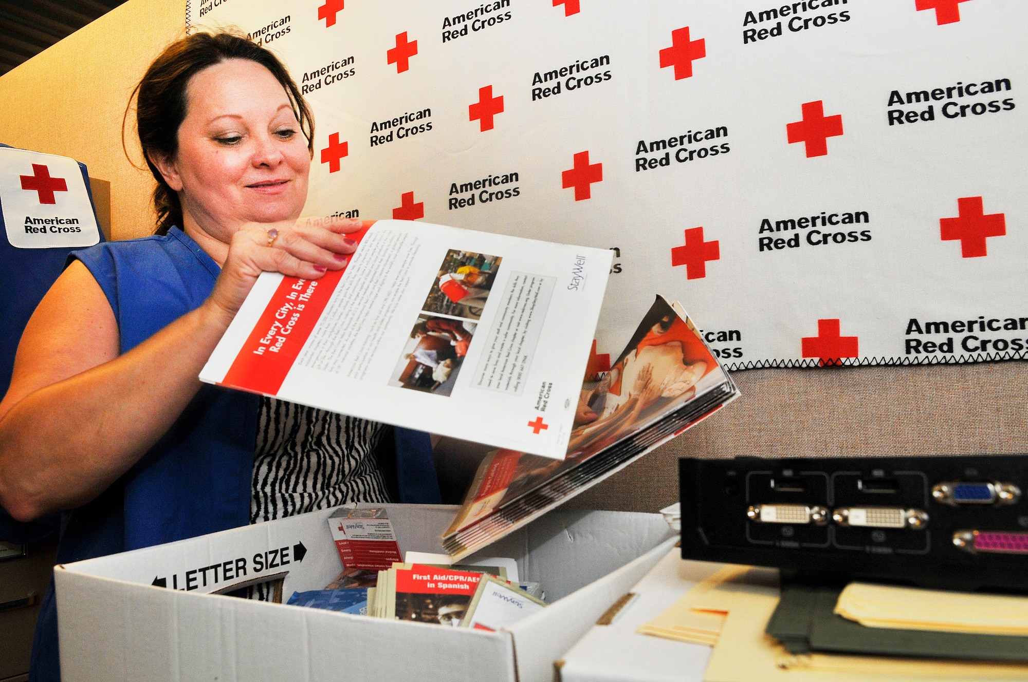 Judy Dienst unpacks office materials at the Airmen and Family Readiness Center Aug. 6. Dienst is the American Red Cross volunteer coordinator for Robins. (U. S. Air Force photo/Sue Sapp)