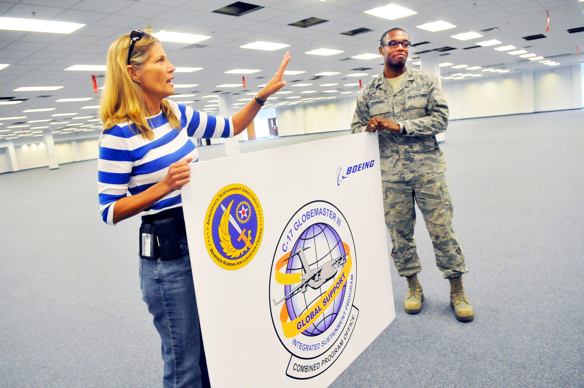 Lisa Poole, and Capt. Timothy Stephens, talk about Phase 1 of the renovations to the old commissary. (U. S. Air Force photo/Sue Sapp)