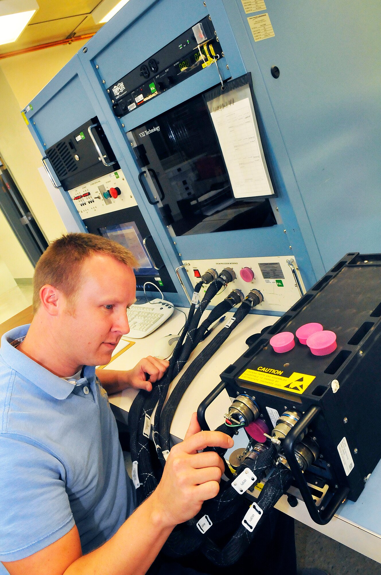 Michael Hunt, electronics technician, downloads information on a processor that is already part of Robins workload. Northrop Grumman Technical Services (NGTS) was recently awarded a $485 million contract to repair the Large Aircraft Infrared Countermeasures (LAIRCM) System.  (U. S. Air Force photo/ Sue Sapp)