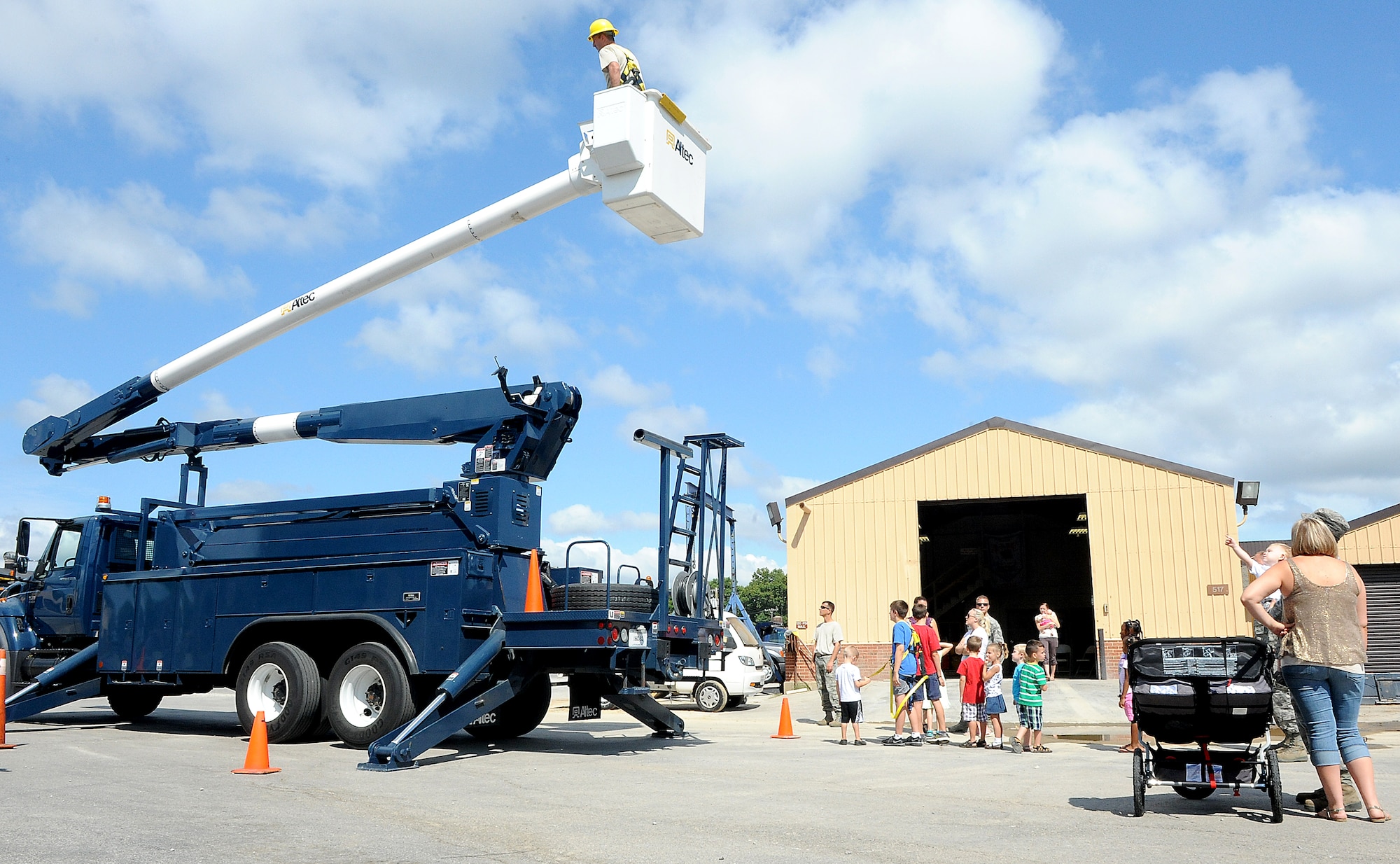 Children wait in line to go up inside of a bucket truck Aug 10 at Scott Air Force Base, Ill. Members of the 375th Civil Engineer Squadron let the children go up in the bucket truck and see what it's like to be high up in the air. The CE members made sure the kids were strapped in with the proper protective gear before raising the bucket. (U.S. Air Force photo/Amn Kristina Lynch)