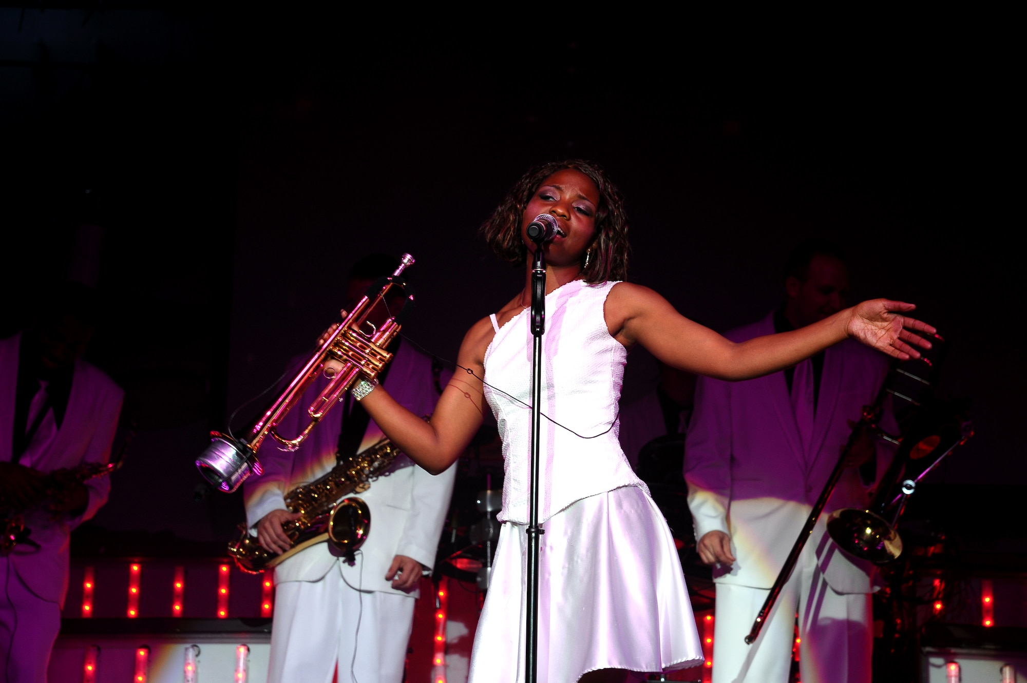 Airman 1st Class Jessica Pitts, Tops in Blue 2012 trumpet player, shows the audience how versatile she is by playing the trumpet and singing during the Tops in Blue “Listen!” 2012 World Tour Aug. 11 in Columbus, Miss.  The Tops in Blue “Listen!” tour will be performed approximately 130 times during the tour’s 10-month duration.  (U.S. Air Force Photo/Airman 1st Class Charles Dickens)