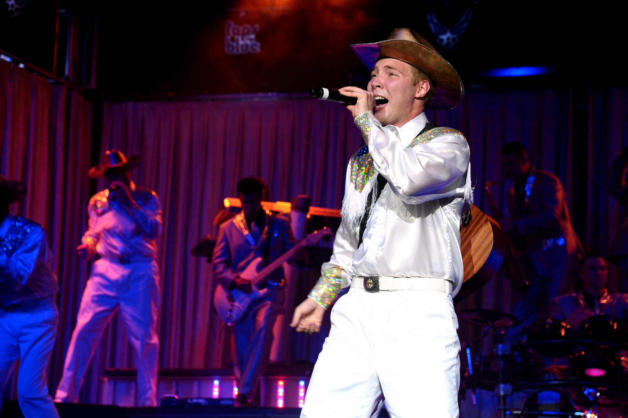 Airman 1st Class Timothy Sentz, Tops in Blue 2012 vocalist, makes a country-themed performance during the Tops in Blue “Listen!” 2012 World Tour Aug. 11 in Columbus, Miss.  During the 59 years that Tops in Blue has been performing they have made appearances on national television, produced albums and made performances on film in addition to their world tours. (U.S. Air Force Photo/Airman 1st Class Charles Dickens)