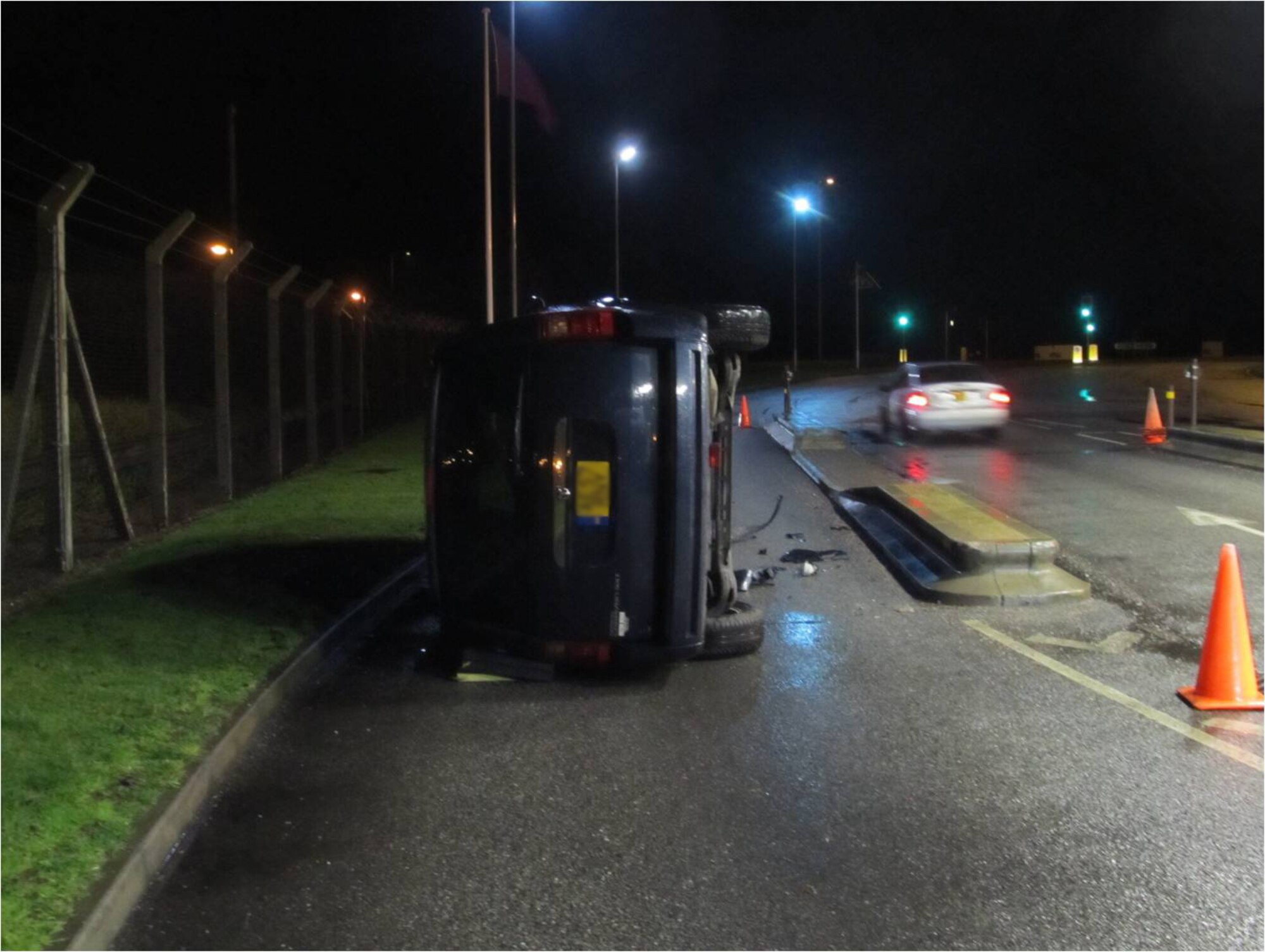 ROYAL AIR FORCE LAKENHEATH, England - A vehicle rests on its side after being flipped in a five mph zone outside the front gate March 5, 2012. If you see anyone driving erratically, passing in no pass zones, not wearing seatbelts, texting or talking on their cell phone while driving, email trafficspotter@lakenheath.af.mil. (Courtesy photo)