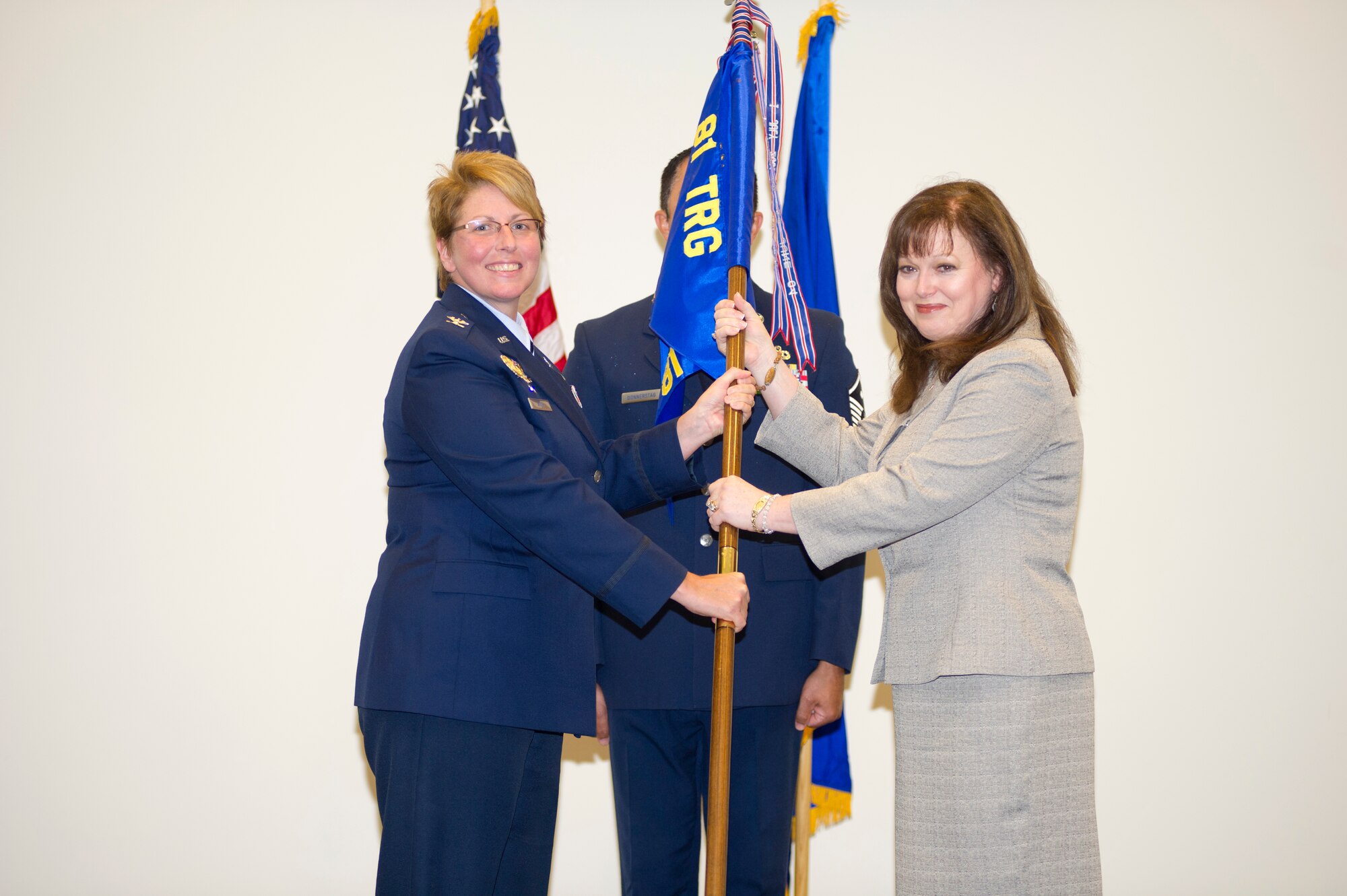 Col. Maureen Smith, 81st Training Group commander, passes the guidon to Debbie Sterling who assumed command of the 81st Training Support Squadron during an assumption of leadership ceremony Aug. 9, 2012, at the Roberts Consolidated Aircraft Maintenance facility, Keesler Air Force Base, Miss.  (U.S. Air Force photo by Adam Bond)